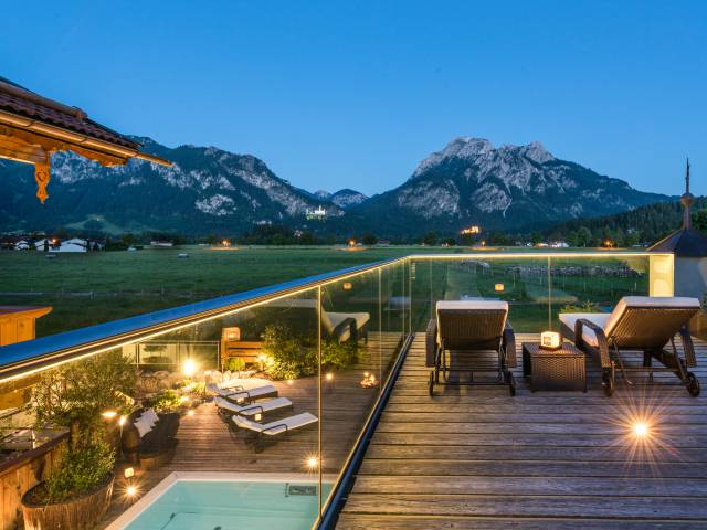 Relaxation loungers at dusk with a view of Neuschwanstein Castle